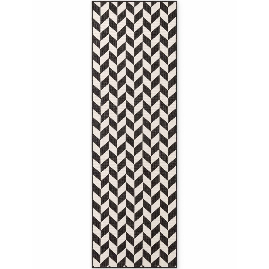 Black and white chevron patterned rug on a white background