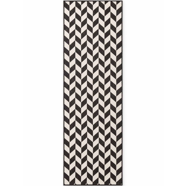Black and white chevron patterned rug on a white background