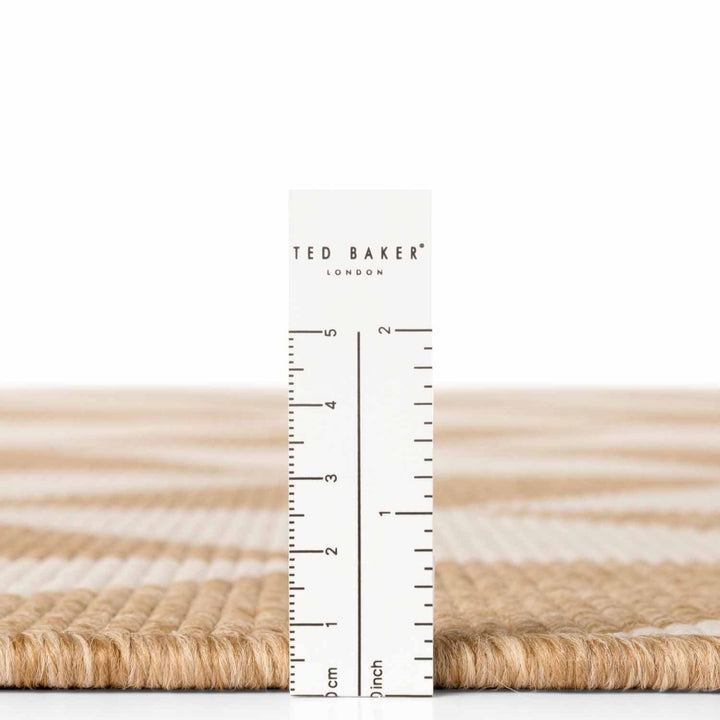 Measurement ruler with 'Ted Baker London' branding on a white background