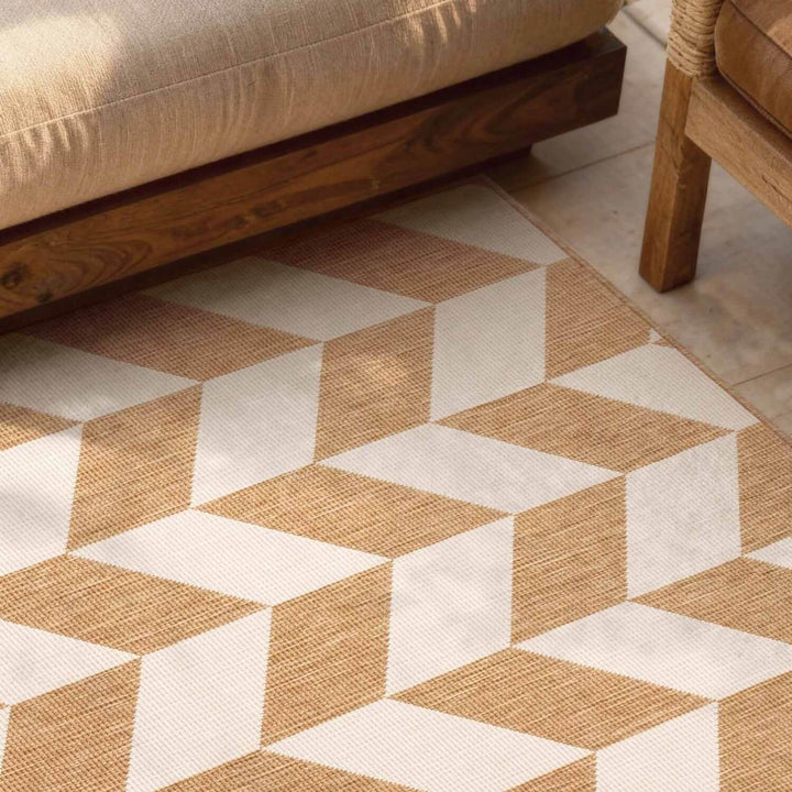Geometric patterned rug with brown and beige colors on a wooden floor.