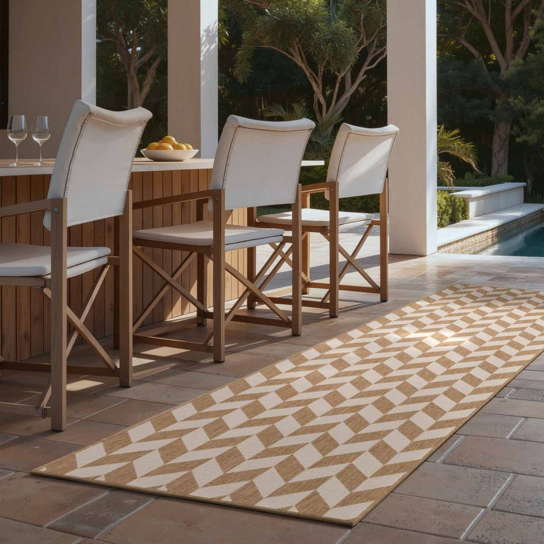 Outdoor dining area with wooden chairs and a patterned rug on a patio.