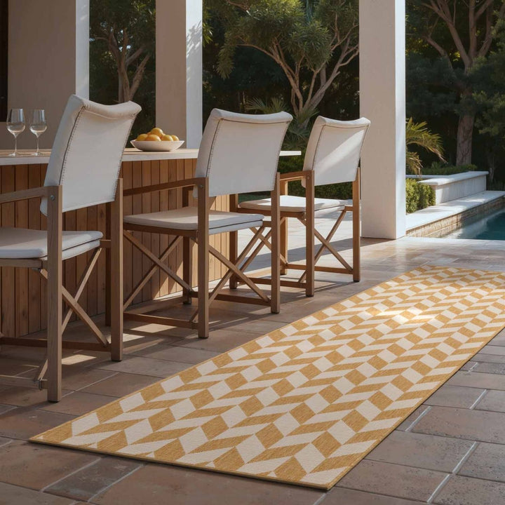 Outdoor patio setting with wooden chairs, table, and patterned rug.