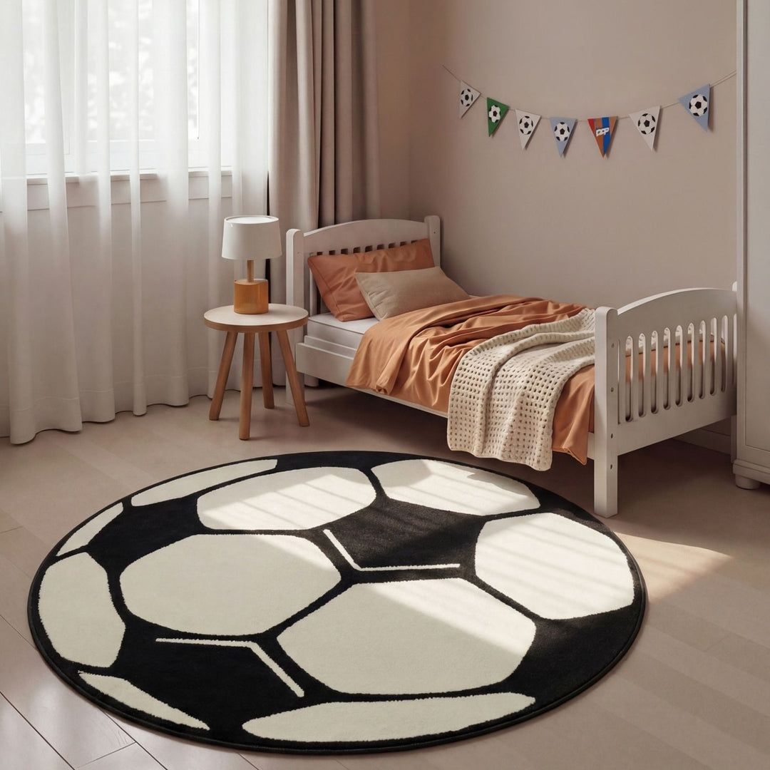 Children's bedroom with a soccer ball-shaped rug, bed, and small table.