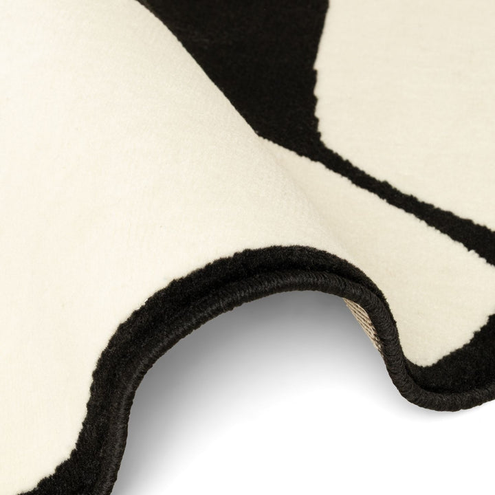 Close-up of a black and white patterned rug corner