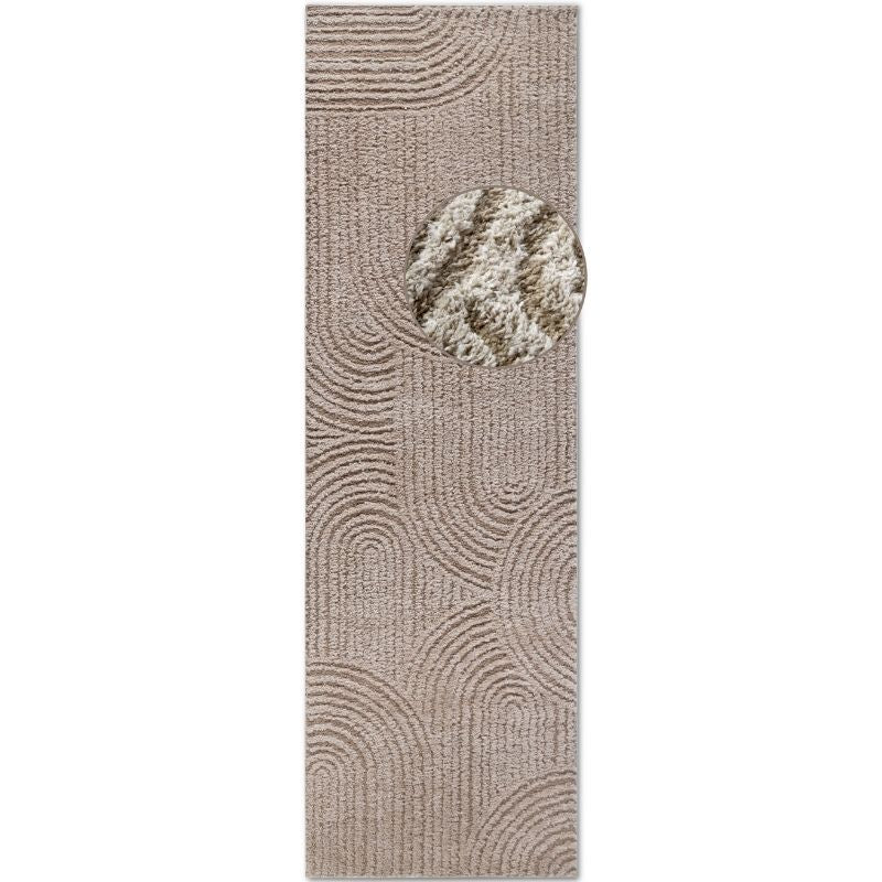 Textured beige runner rug with a circular pattern on a white background