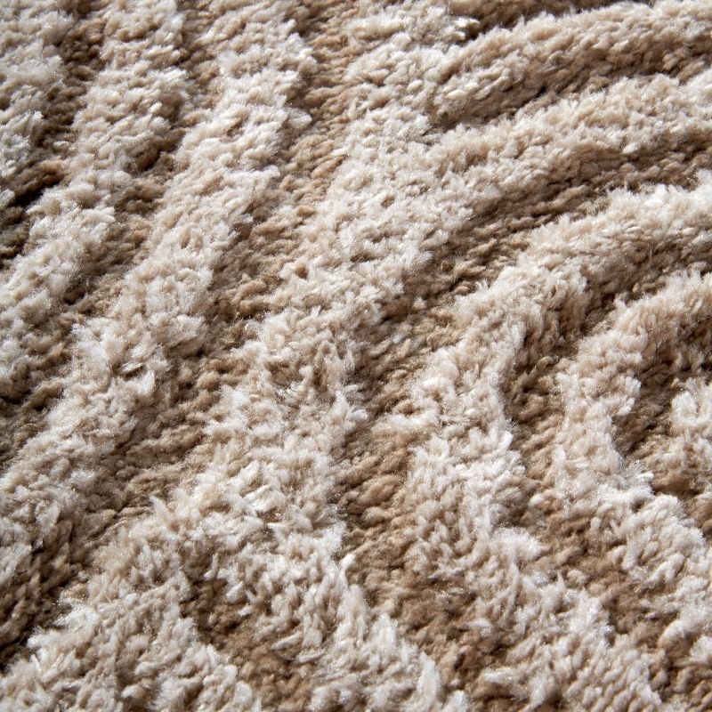 Close-up of a textured beige and brown carpet