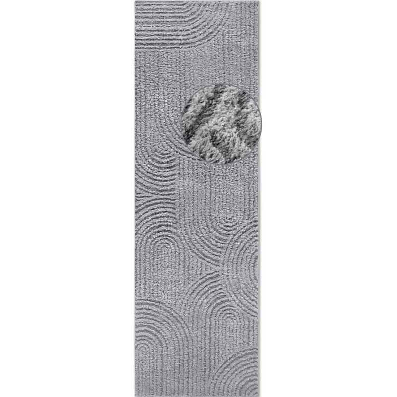Gray textured doormat with a circular design on a white background