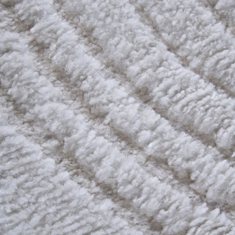 Close-up of textured beige carpet with diamond pattern