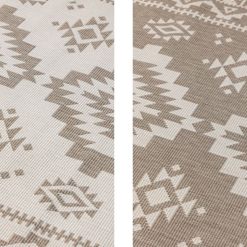 Close-up of a patterned fabric with geometric design in beige and white.