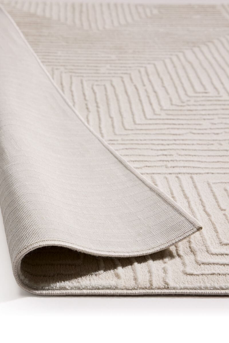 Abstract geometric rug in cream shades, showcasing the texture and softness of its surface, ideal for modern interiors.