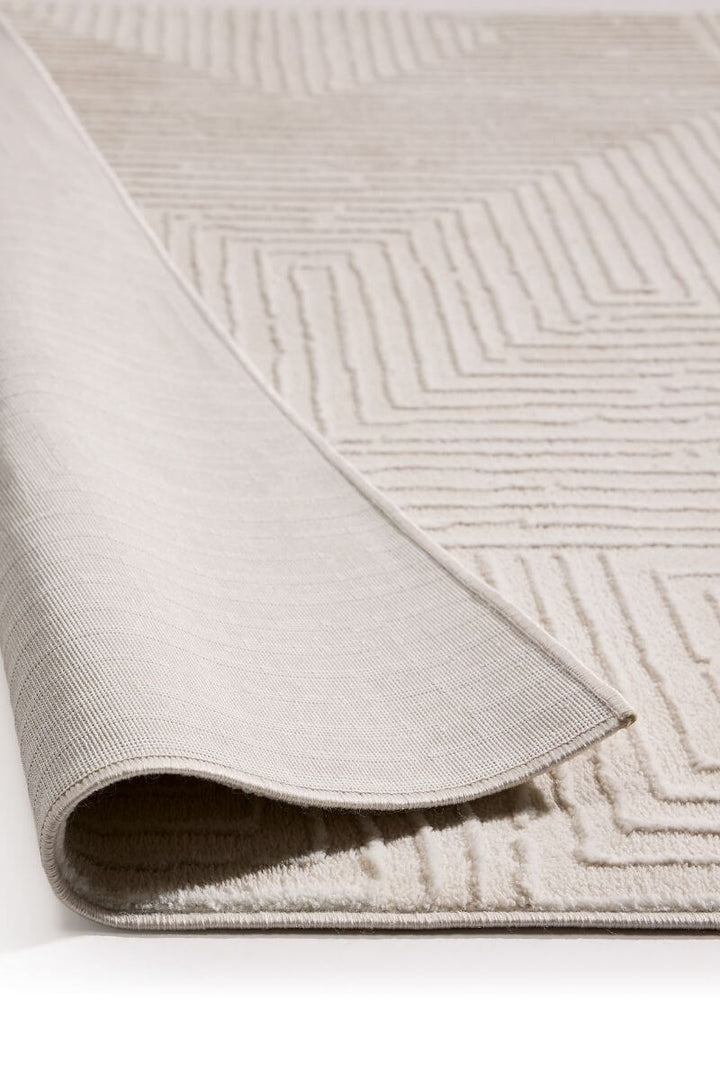 Abstract geometric rug in cream shades, showcasing the texture and softness of its surface, ideal for modern interiors.
