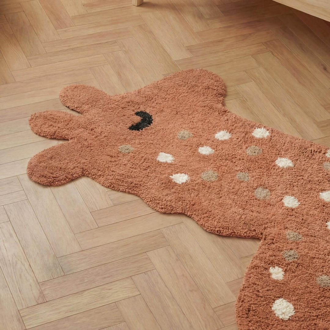 Brown bear-shaped rug on a wooden floor