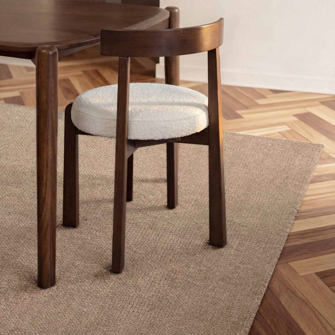 Wooden chair with a cushioned seat on a wooden floor
