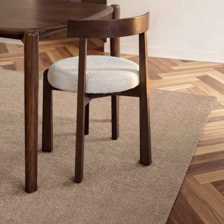 Wooden chair with a cushioned seat on a wooden floor