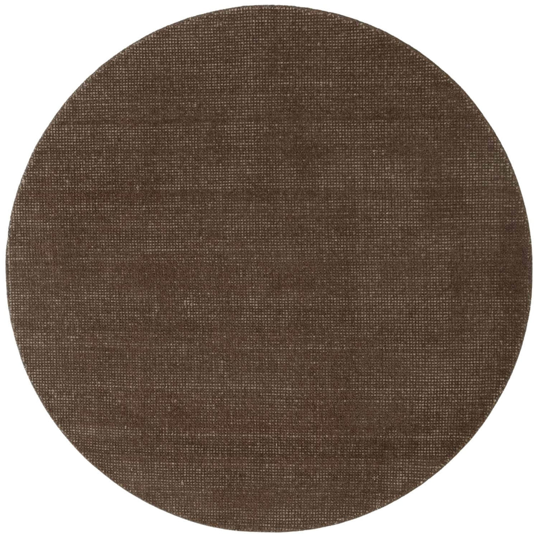 Round brown rug with a textured surface on a white background