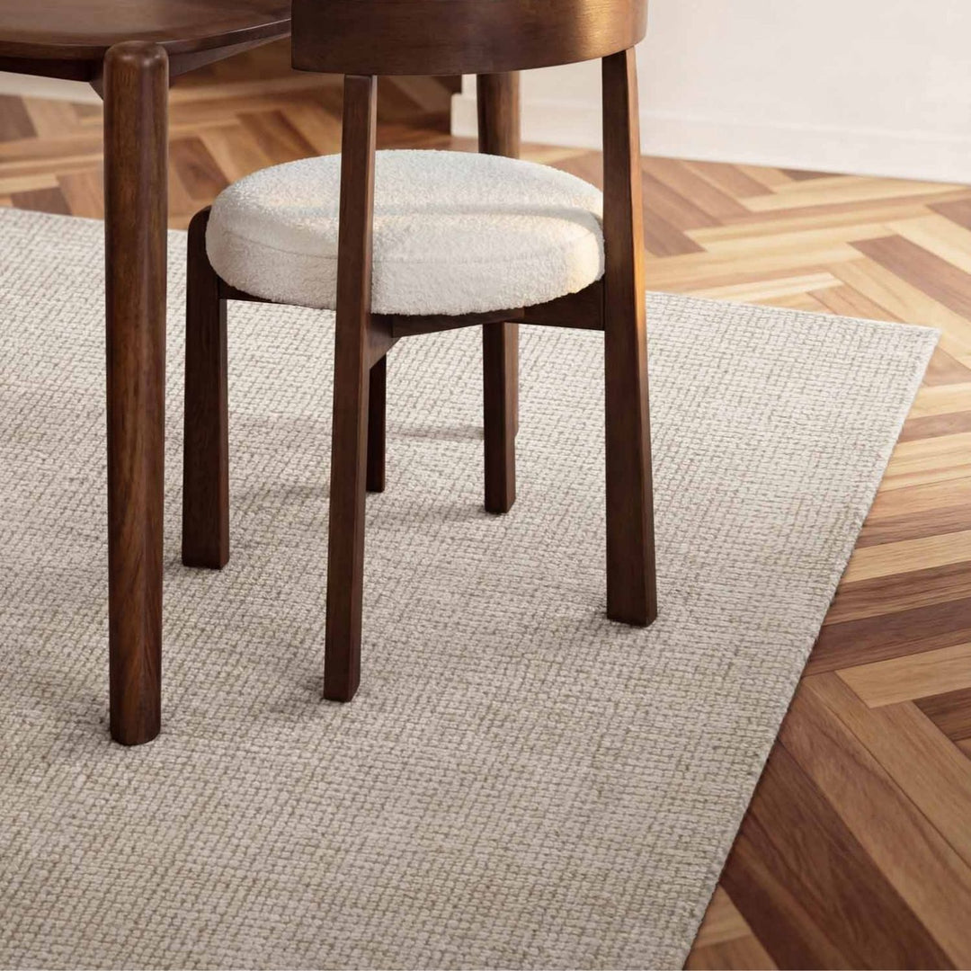 Wooden chair with a white cushion on a wooden floor