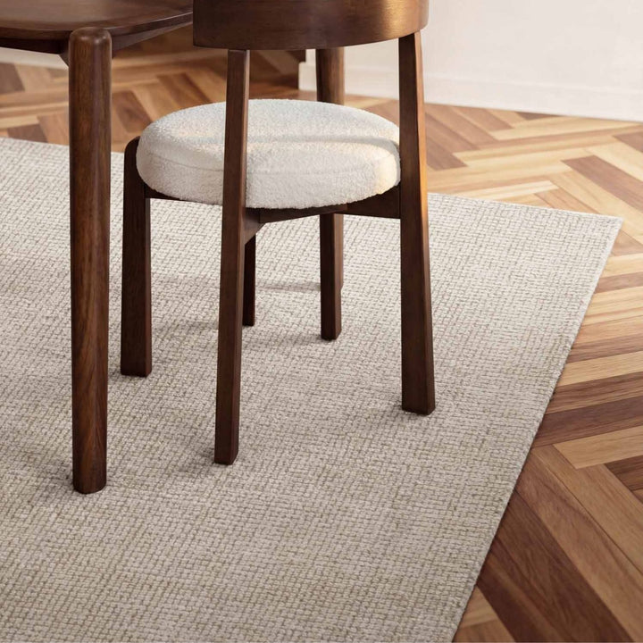 Wooden chair with a white cushion on a wooden floor
