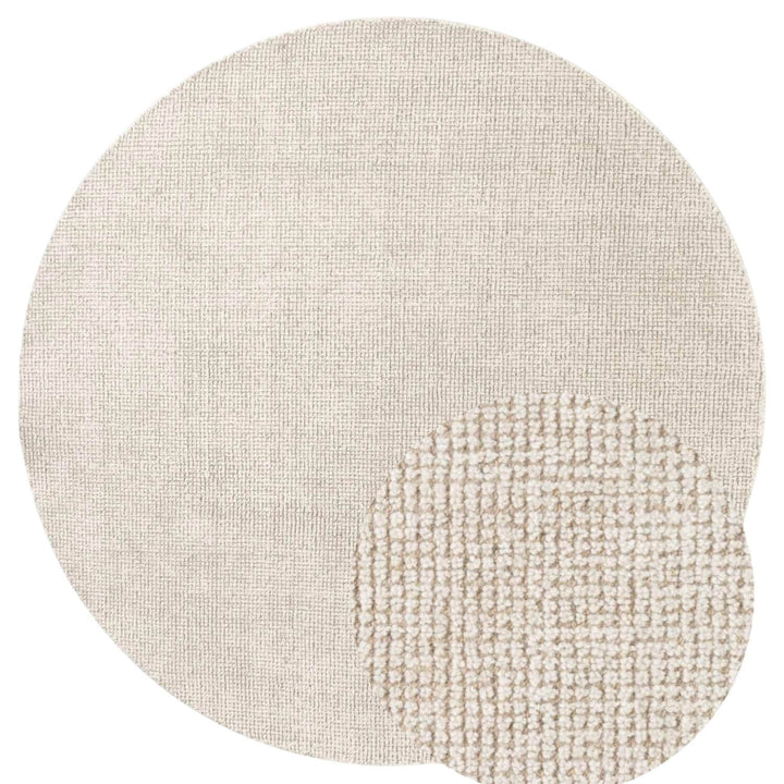 Textured beige rug with a circular design on a white background