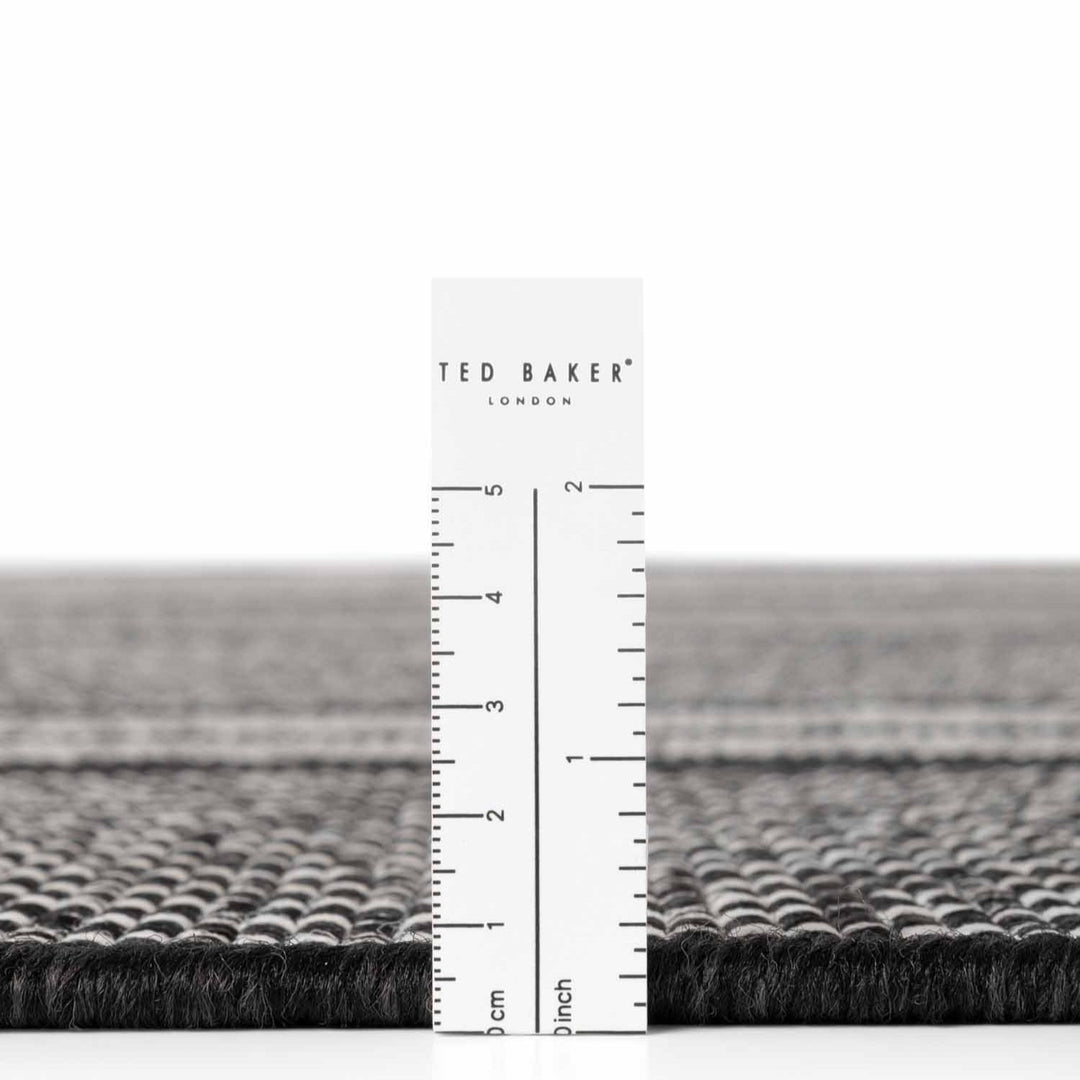 Ted Baker London rug with a ruler for scale on a white background