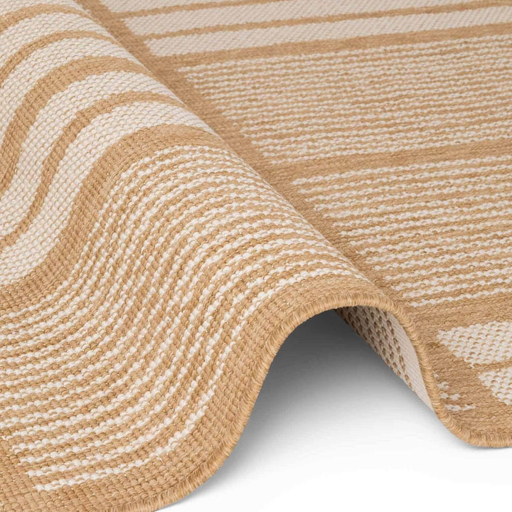 Close-up of a beige and white striped rug on a white background