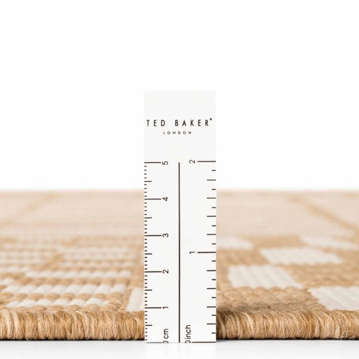Ted Baker London rug with a ruler for scale on a white background