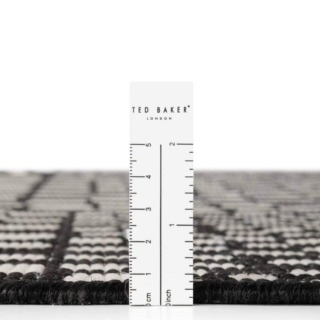 Ted Baker London rug with a ruler for scale on a white background