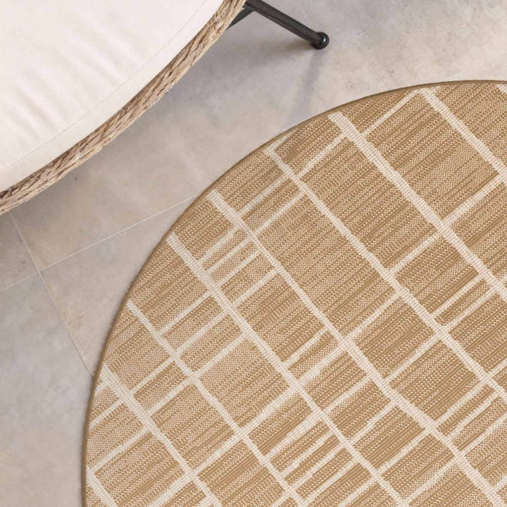 Round beige and white checkered rug on a tiled floor
