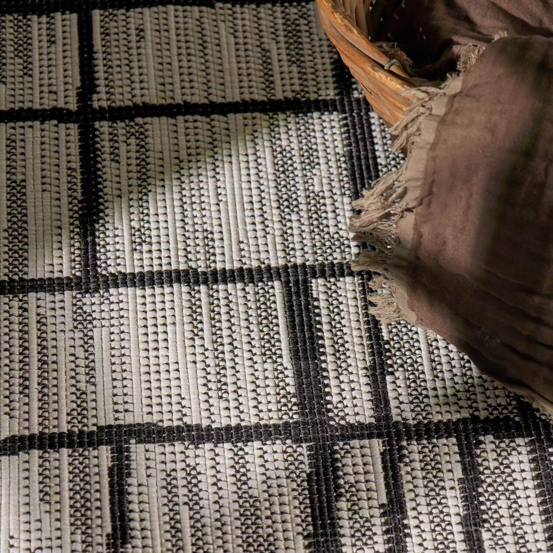 Close-up of a woven rug with a basket on top