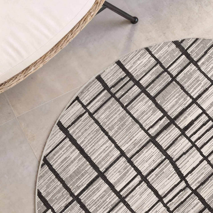 Round geometric patterned rug on a tiled floor