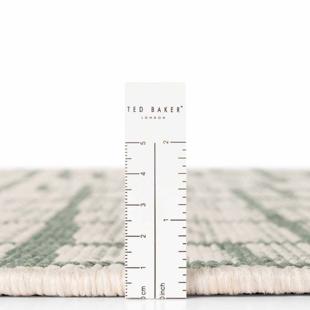 Ted Baker London rug with a ruler for scale on a white background