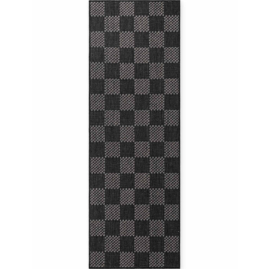 Black and gray checkered rug on a white background