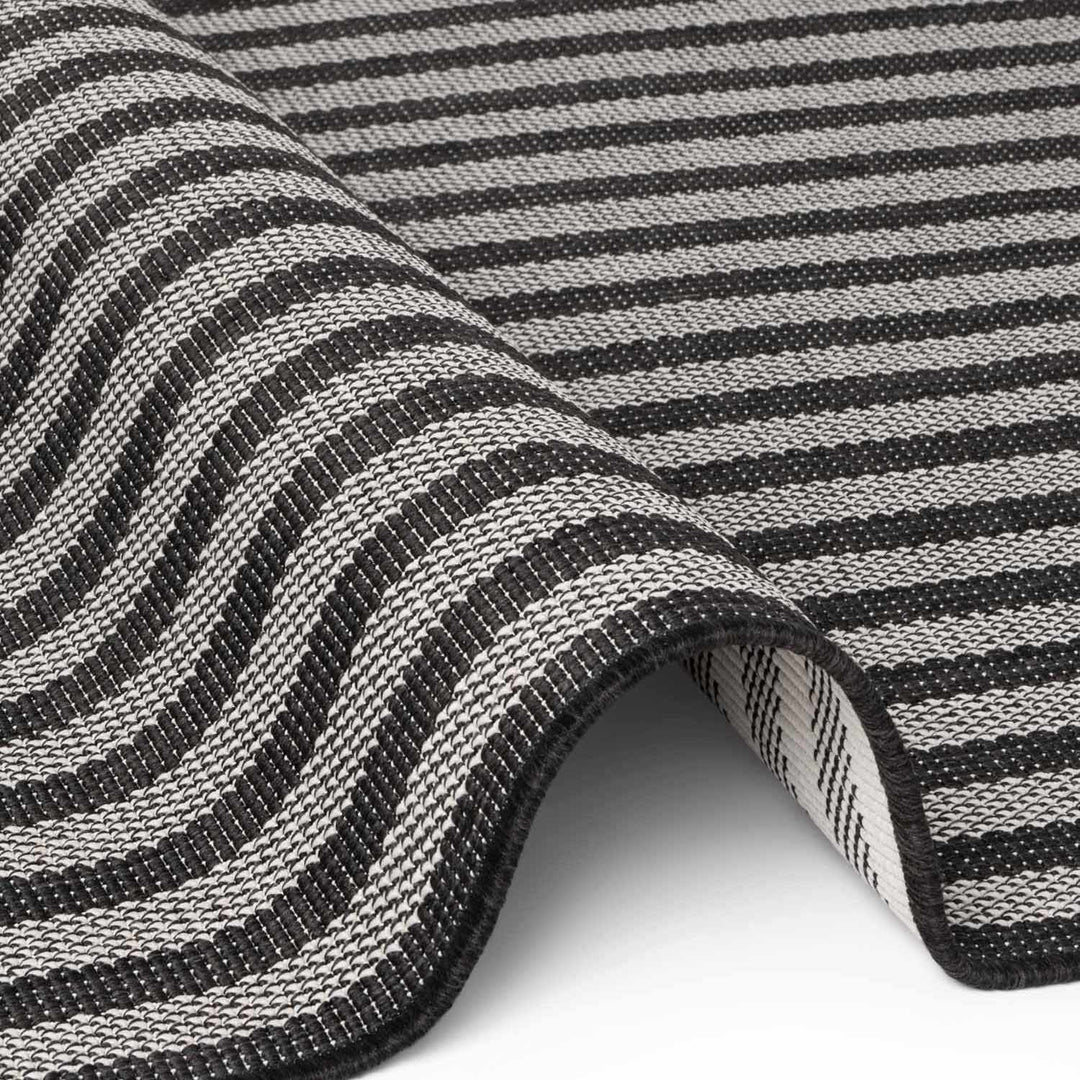 Close-up of a black and white striped fabric with a wavy pattern.
