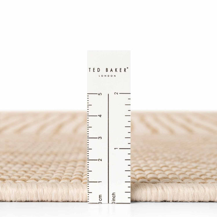 Ted Baker fabric swatch with a ruler for scale on a white background