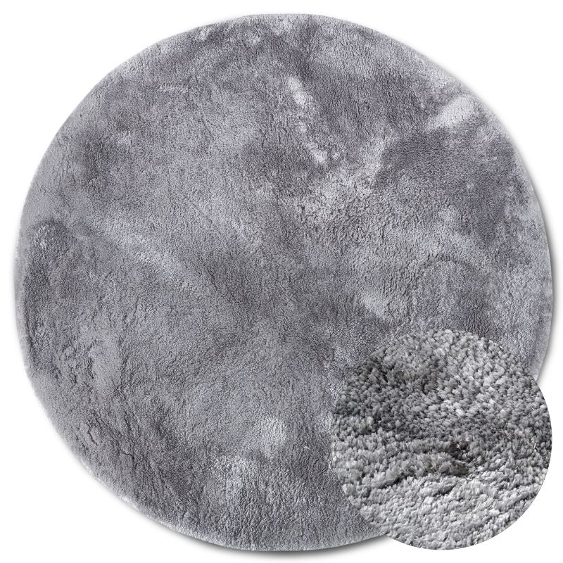Round gray rug with textured surface on a white background