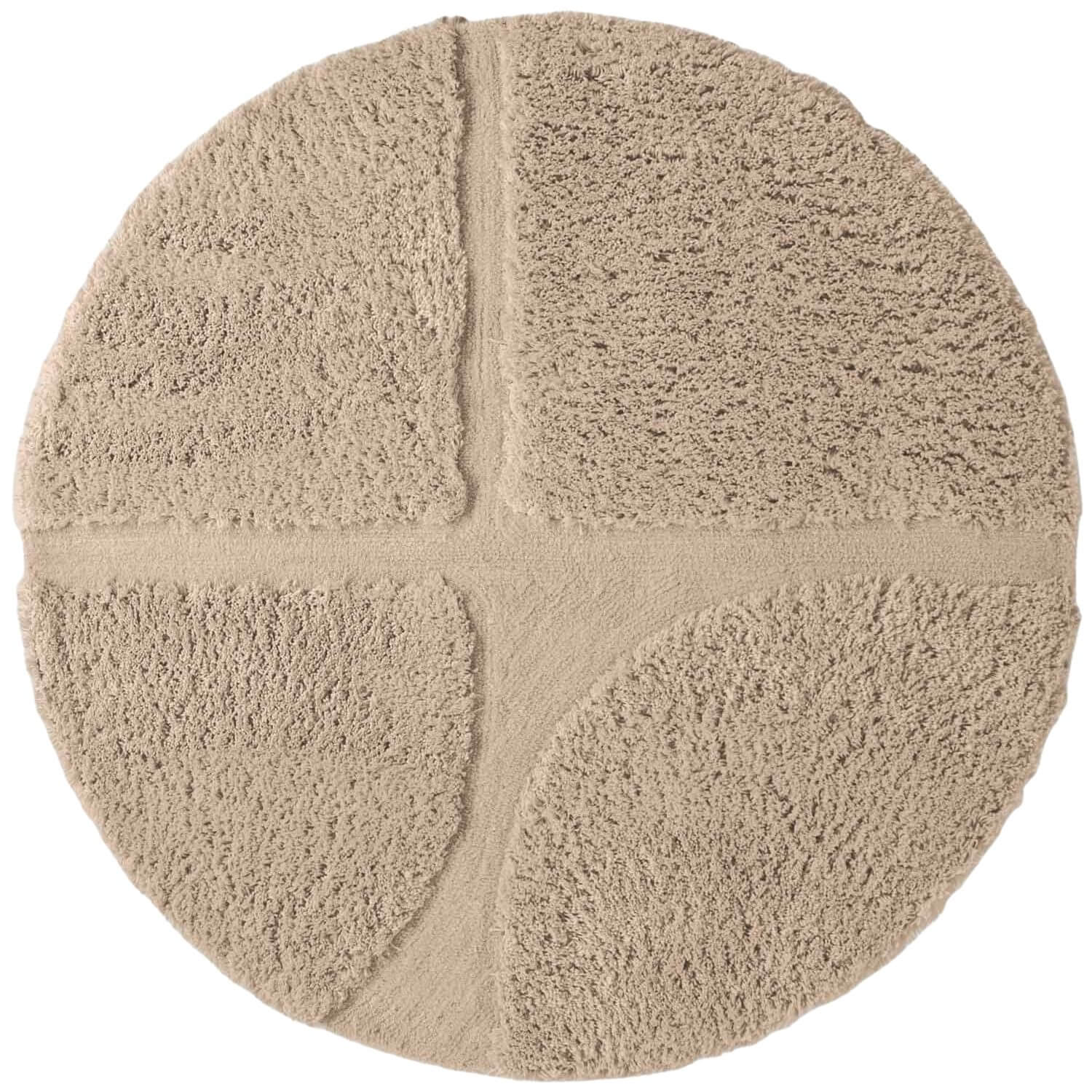Round beige rug with a textured surface on a white background