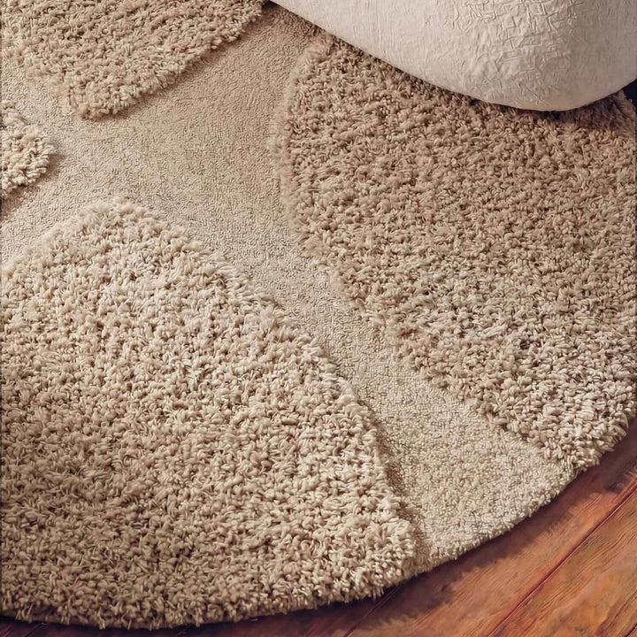Beige shaggy rug on a wooden floor