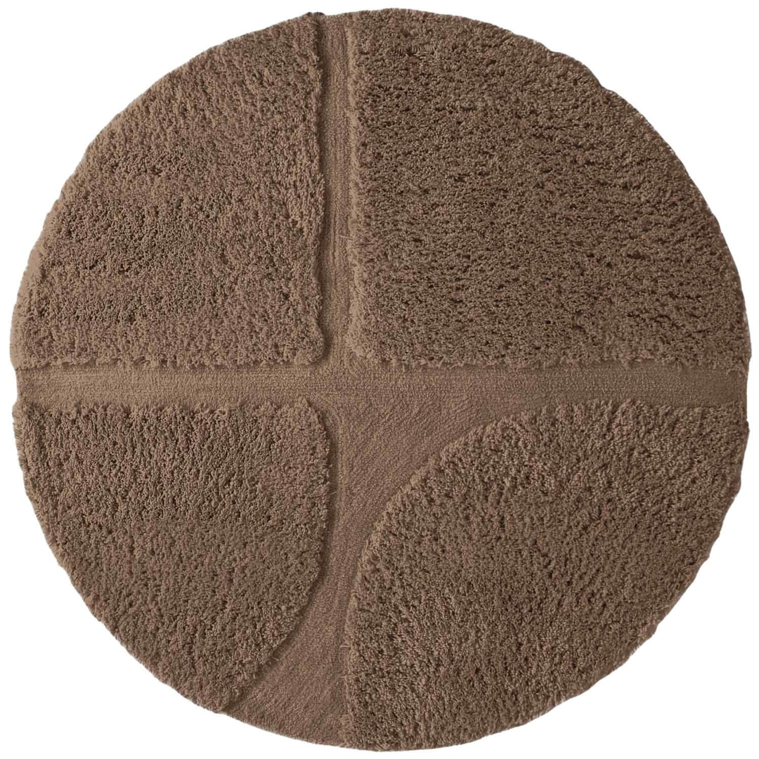 Round brown bath mat with textured surface on a white background