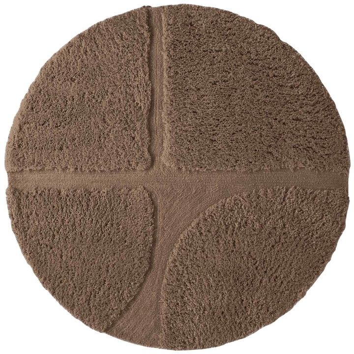 Round brown bath mat with textured surface on a white background