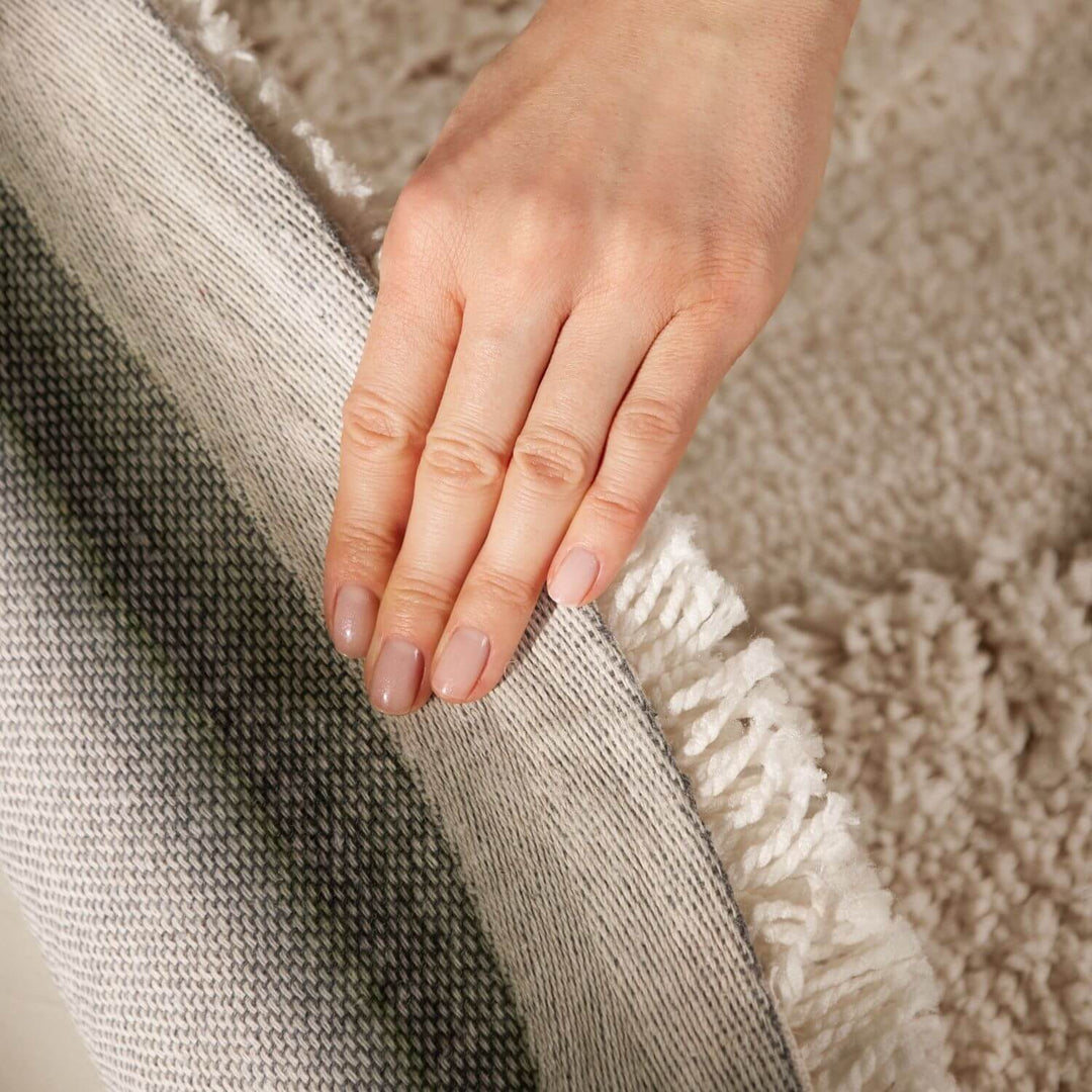 Hand touching a textured fabric surface