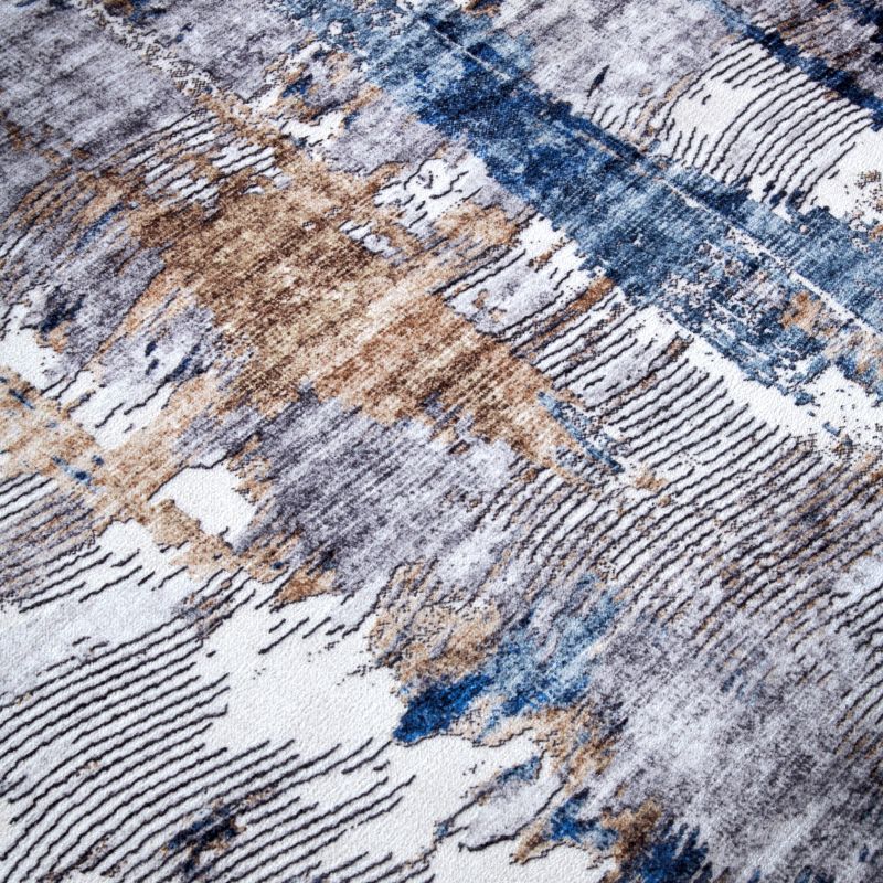 Close-up of a textured rug with geometric pattern in brown, blue, and white.