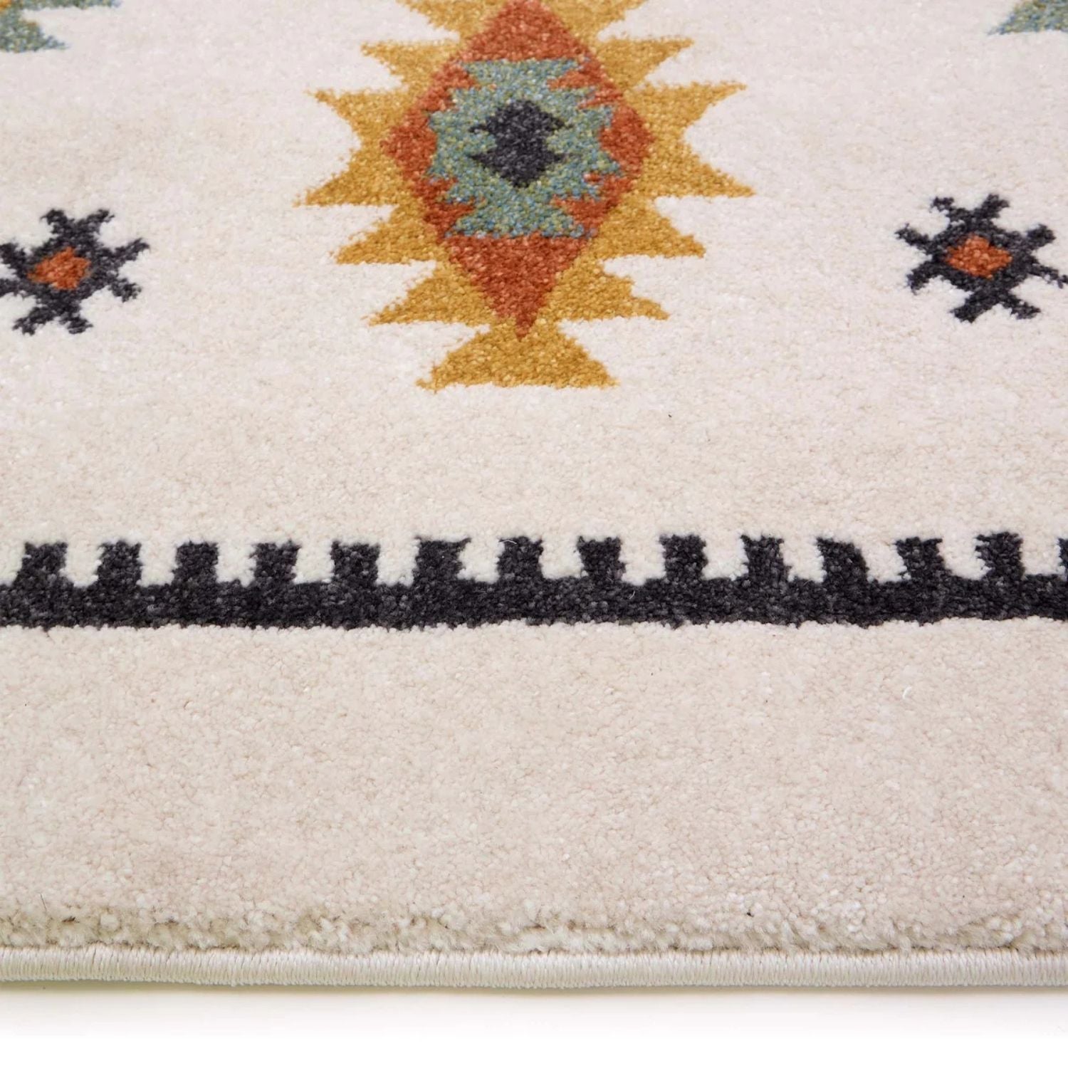 Close-up of a patterned rug with geometric design on a white background