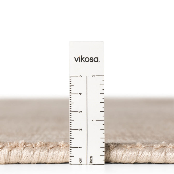 Rug with a ruler showing measurements and 'vikosa' branding on a white background