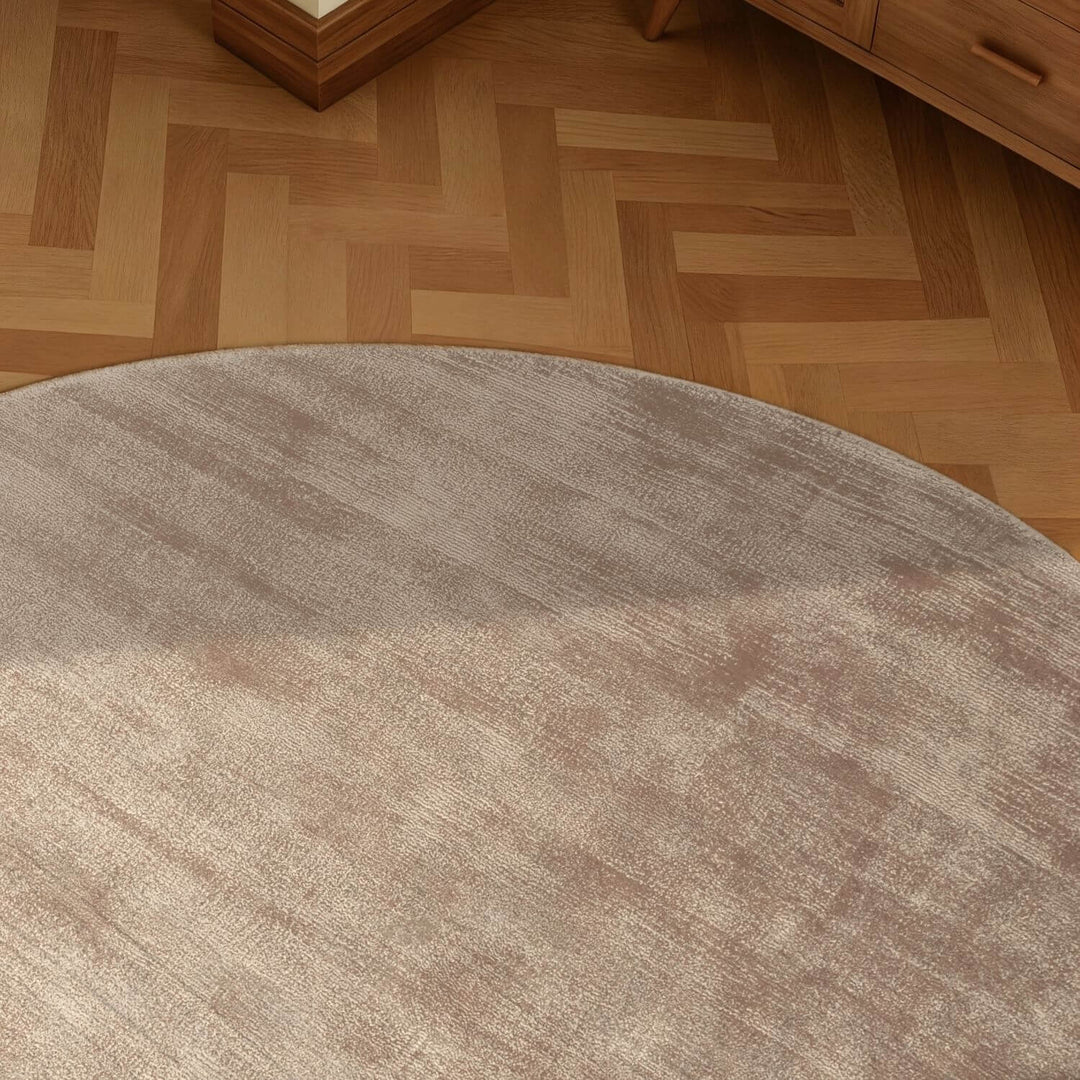 Round brown rug on a wooden floor