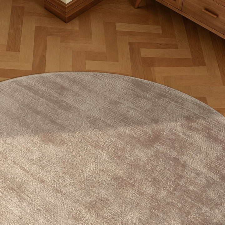 Round brown rug on a wooden floor