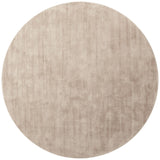 Round beige rug on a white background