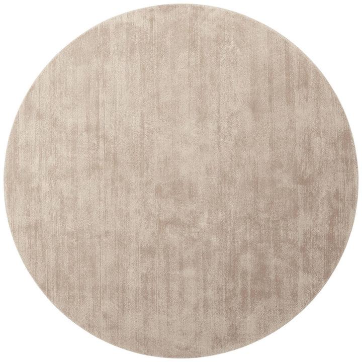 Round beige rug on a white background