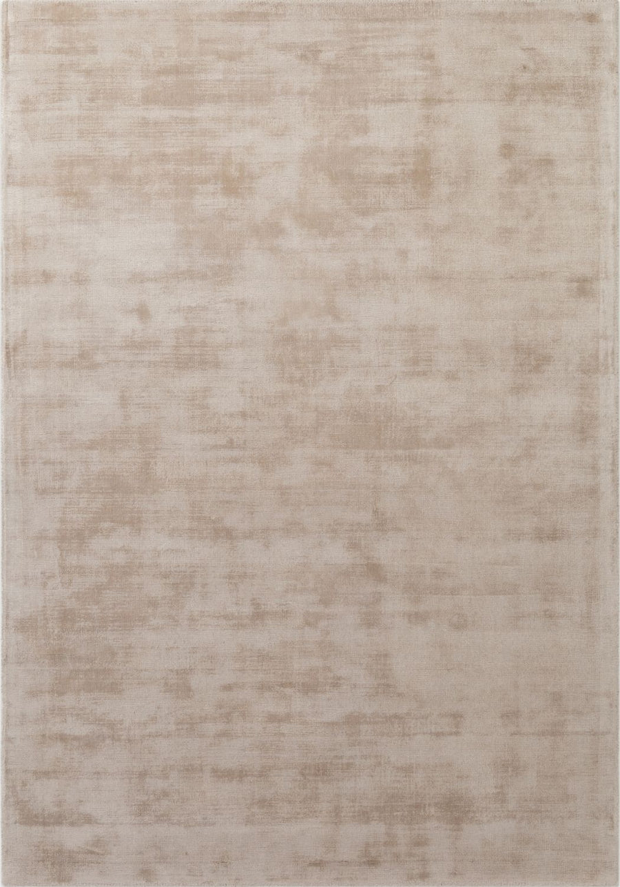 Beige area rug with a subtle pattern on a plain background