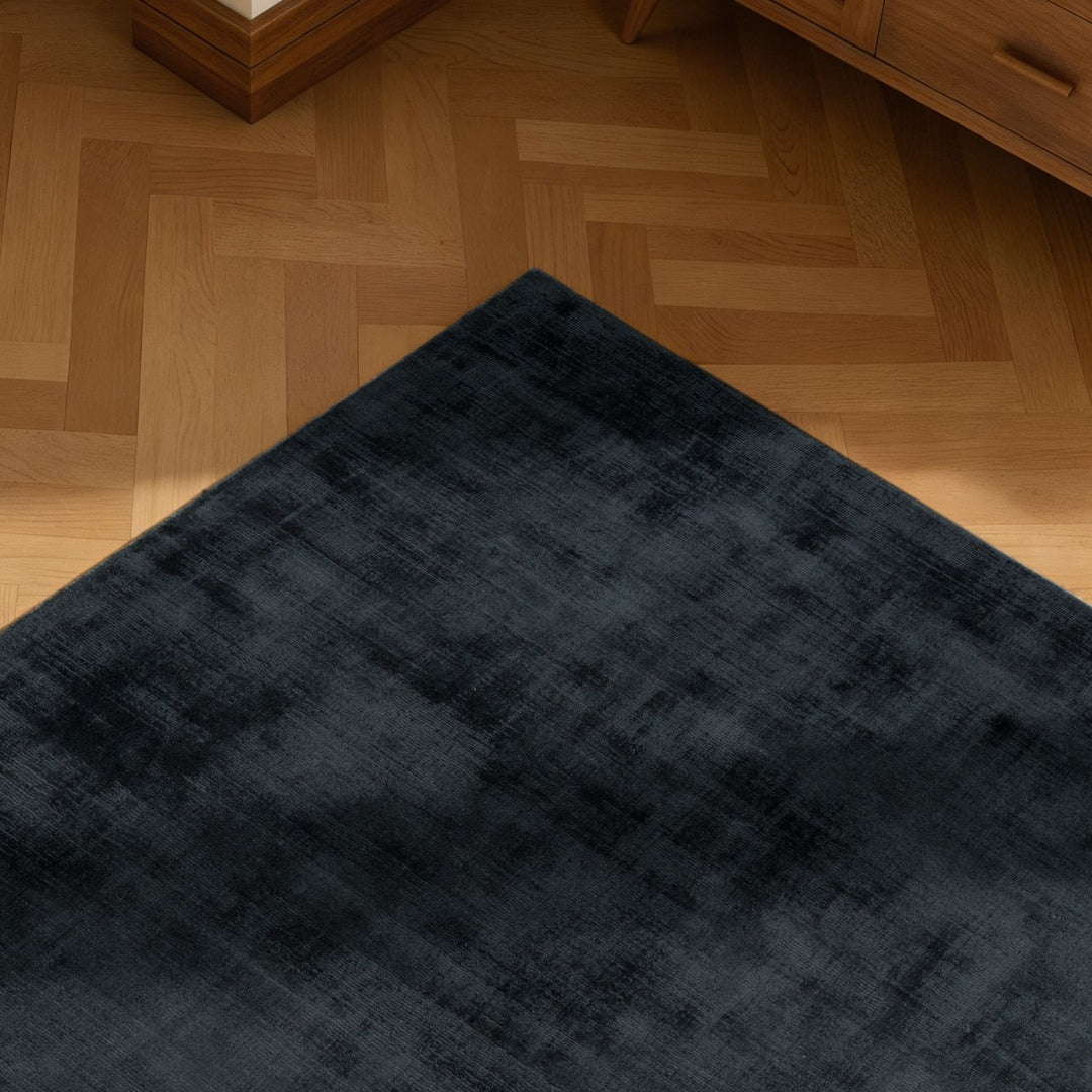 Dark blue rug on a wooden floor