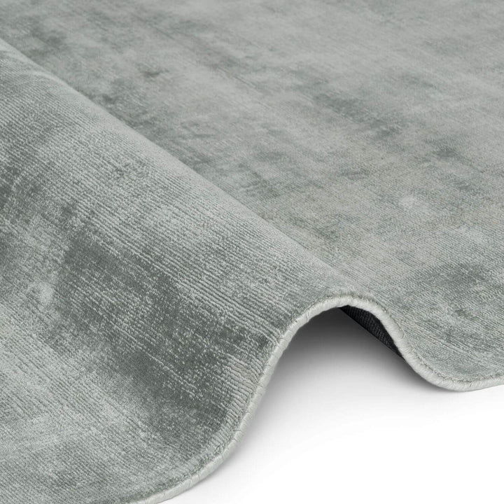 Close-up of a gray textured rug on a white background