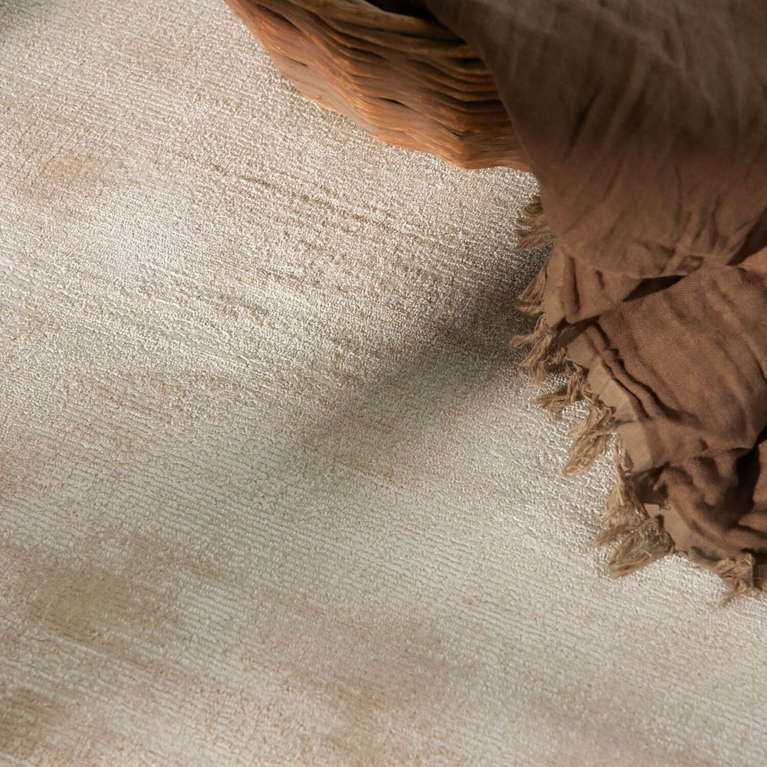 Brown woven basket on a textured beige surface